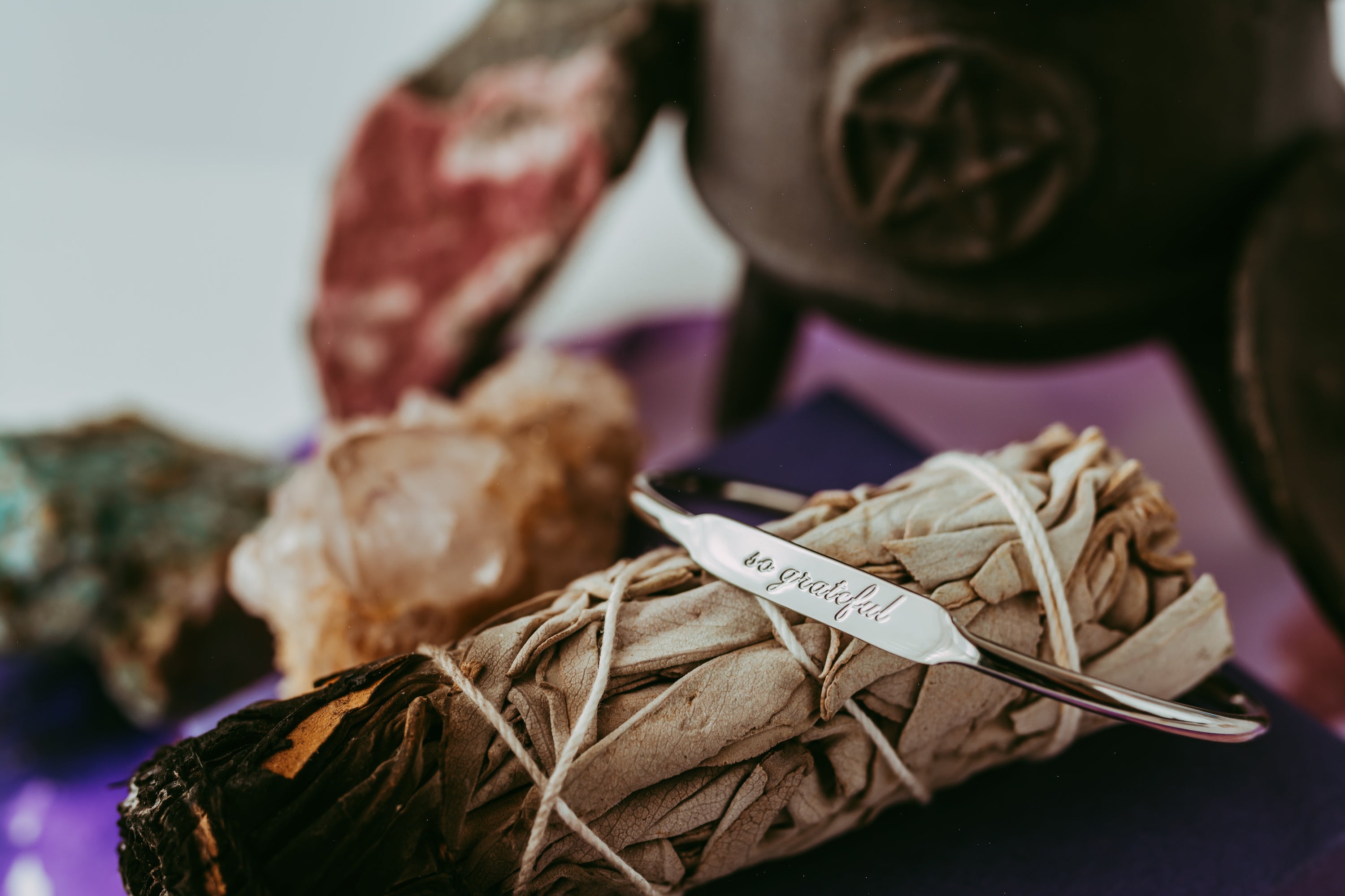 Celtic witchcraft altar with herbs, crystals, sage bundle and ogham-inspired elements for modern practice