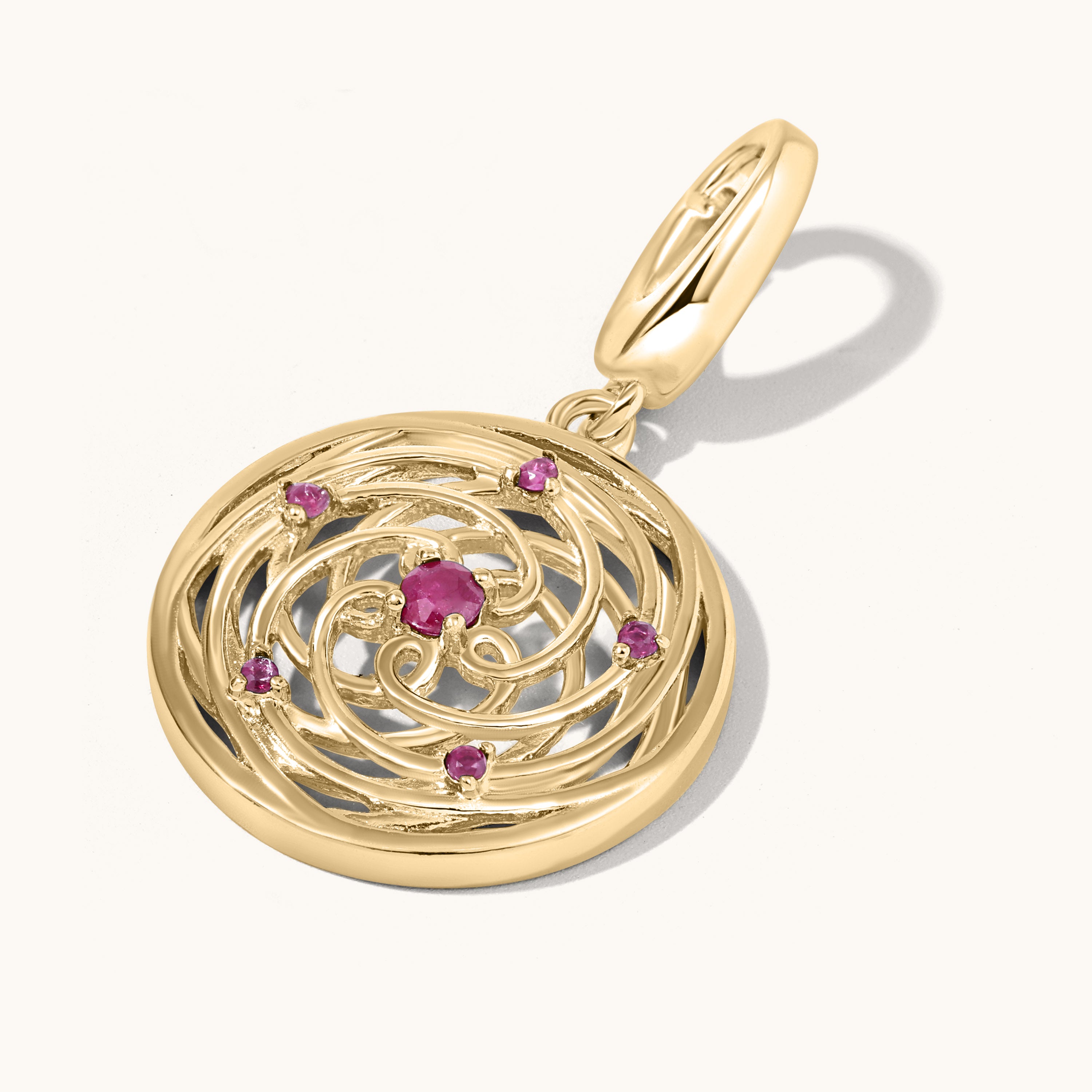 Gold pendant with embedded gemstones on a white background