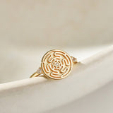 Gold Hecate's Wheel Ring on Cream Background
