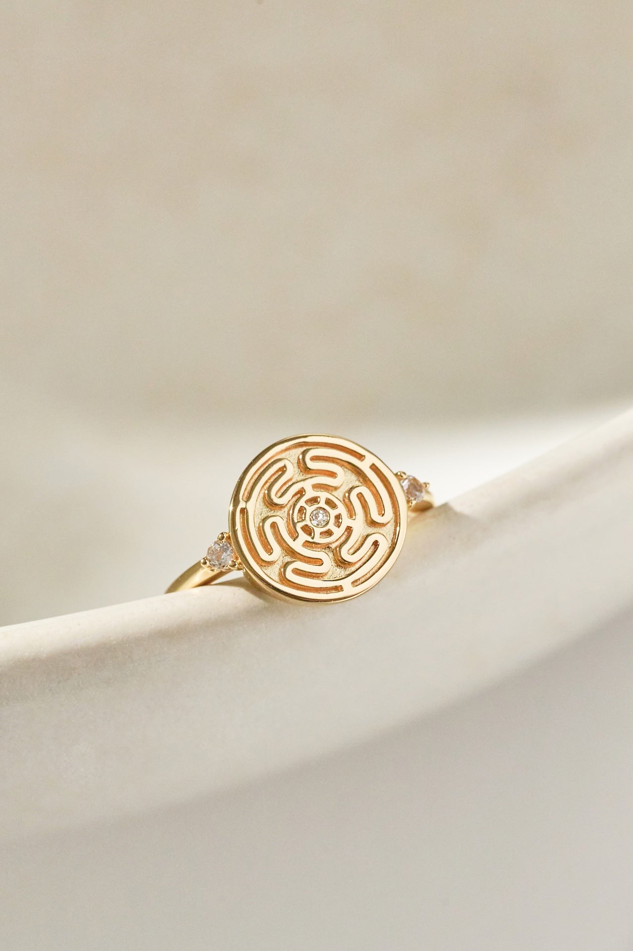 Gold Hecate's Wheel Ring on Cream Background