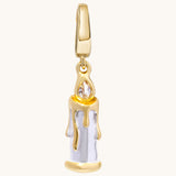 A gold candle charm with sculpted dripping wax and a contrasting metal flame set with a white topaz stone.