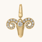 Gold ram head pendant with embedded white topaz stones on a white background