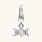 A silver triple moon charm pendant featuring a central round iridescent opal gemstone, set against a plain off-white background.