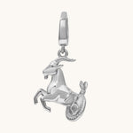 Silver goat pendant charm on a white background