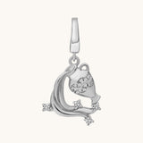 Silver pendant with intricate design of water flowing out of a jar on a white background