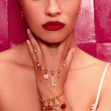 Woman wearing jewelry with a pink background