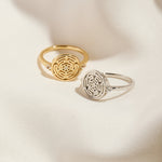 Silver and Gold Hecate's Wheel Rings on Cream Cloth Background