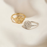 Silver and Gold Hecate's Wheel Rings on Cream Cloth Background