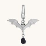 A silver Bat Charm pendant with outstretched wings, black gemstone eyes, and a teardrop-shaped black gem—a bold magick necklace ideal for witch jewelry enthusiasts.