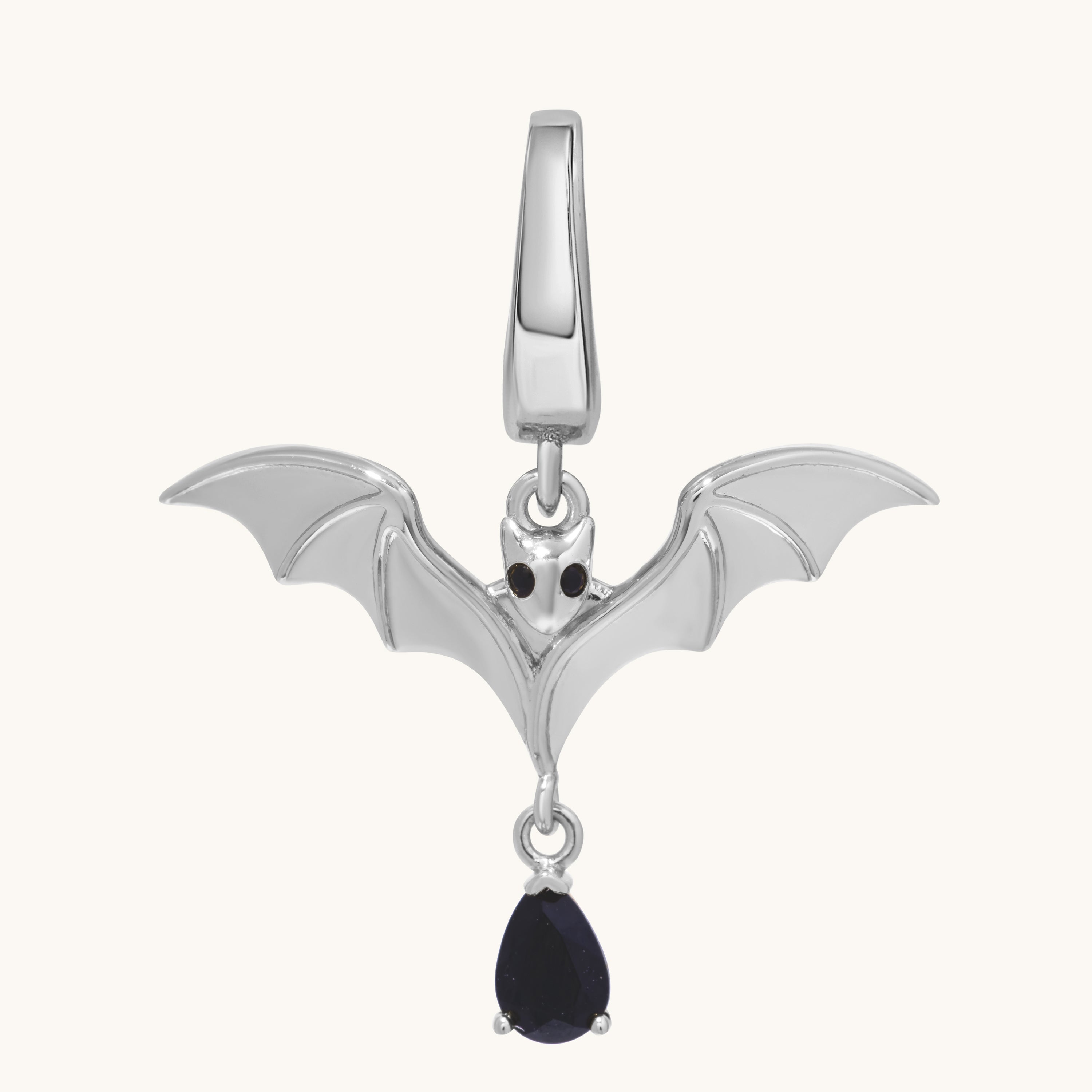 A silver Bat Charm pendant with outstretched wings, black gemstone eyes, and a teardrop-shaped black gem—a bold magick necklace ideal for witch jewelry enthusiasts.