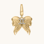 Gold zodiac charm with two faces and a 'II' symbol on a white background