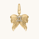 Gold zodiac charm with two faces and a 'II' symbol on a white background