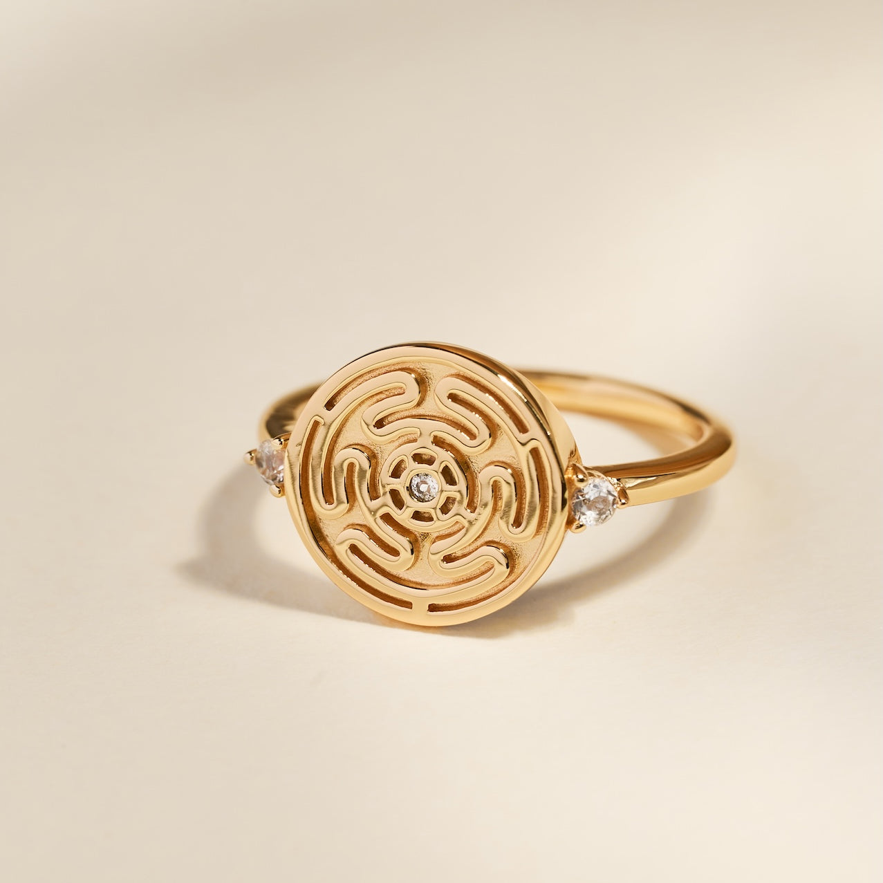 Gold Hecate's Wheel Ring on Cream Background