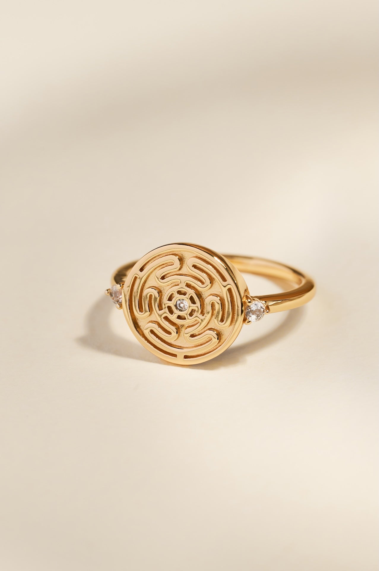 Gold Hecate's Wheel Ring on Cream Background