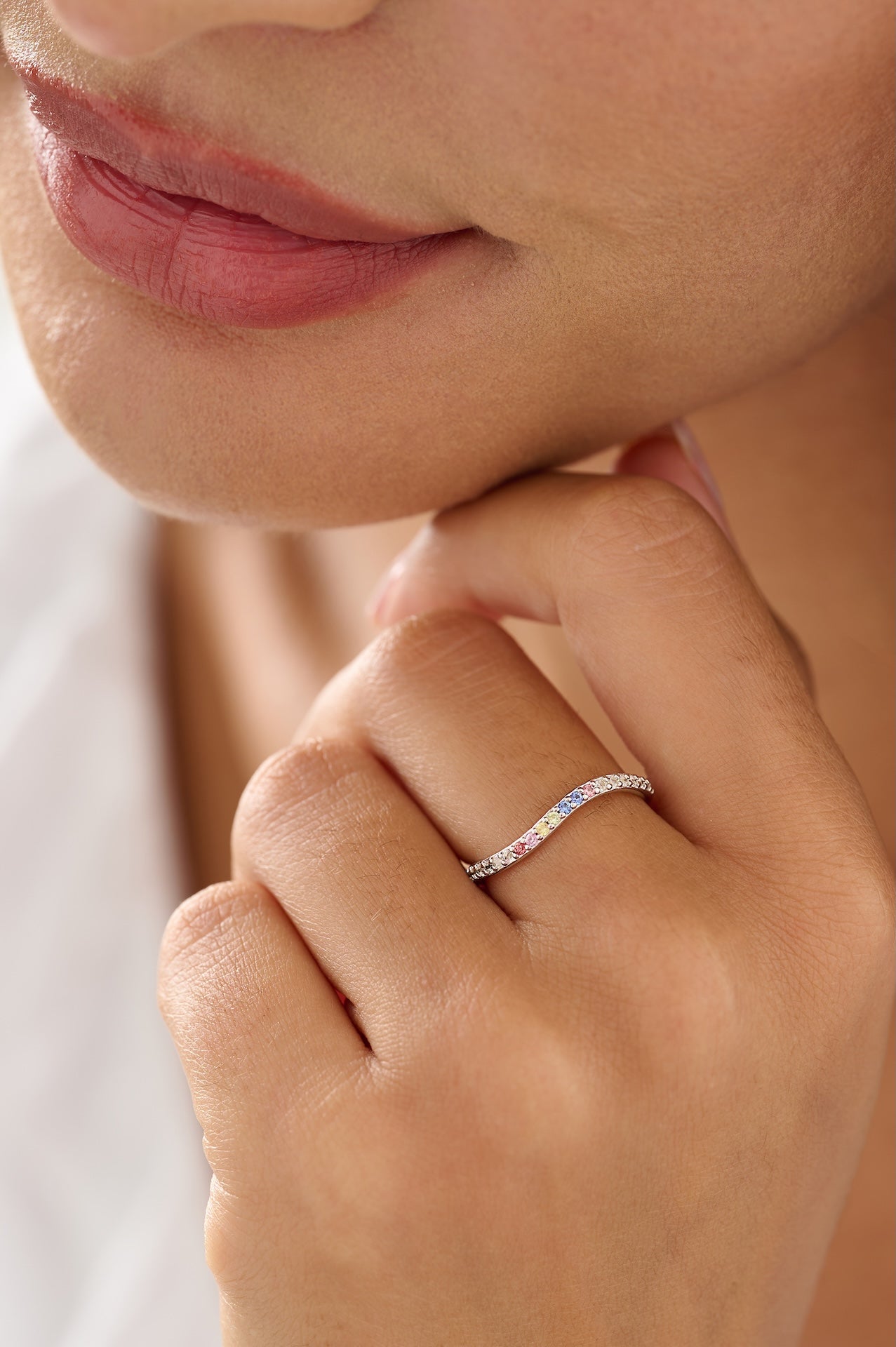 Close-up of a hand wearing a ring with a blurred background