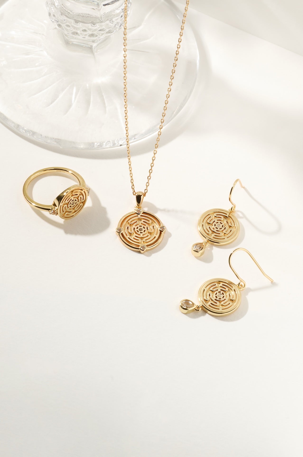 Hecate's Wheel Ring Necklace and Fish hook Earrings set in Gold on white background