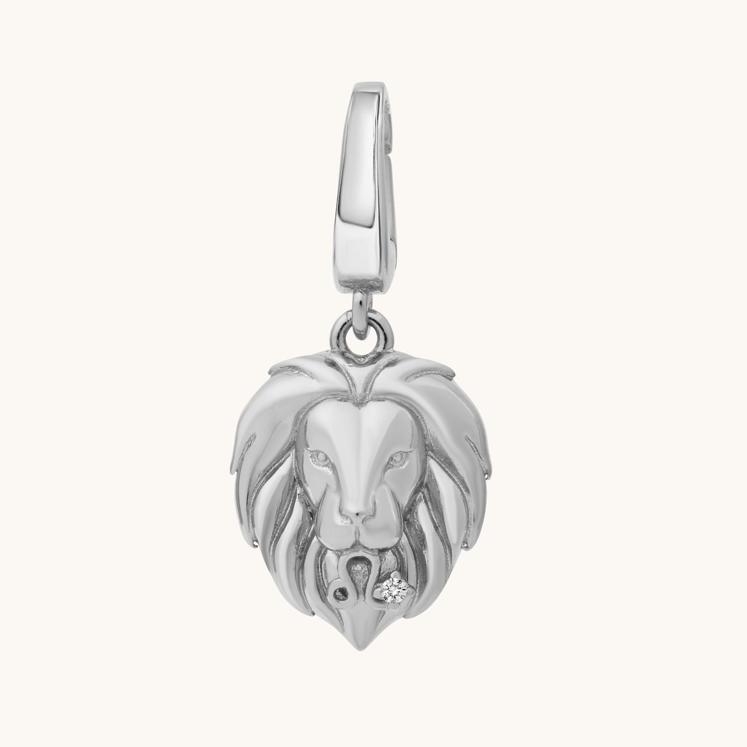 Silver lion head charm on a white background