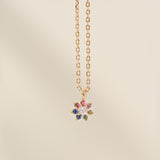 Necklace with a multicolored gemstone pendant on a beige background