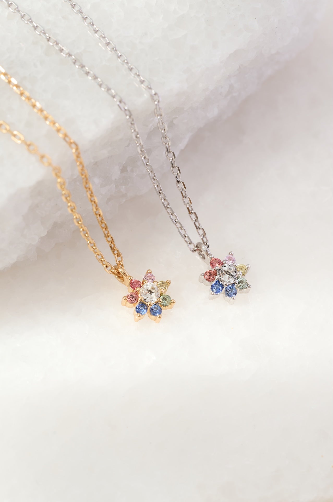 Two necklaces with colorful gemstones on a white background