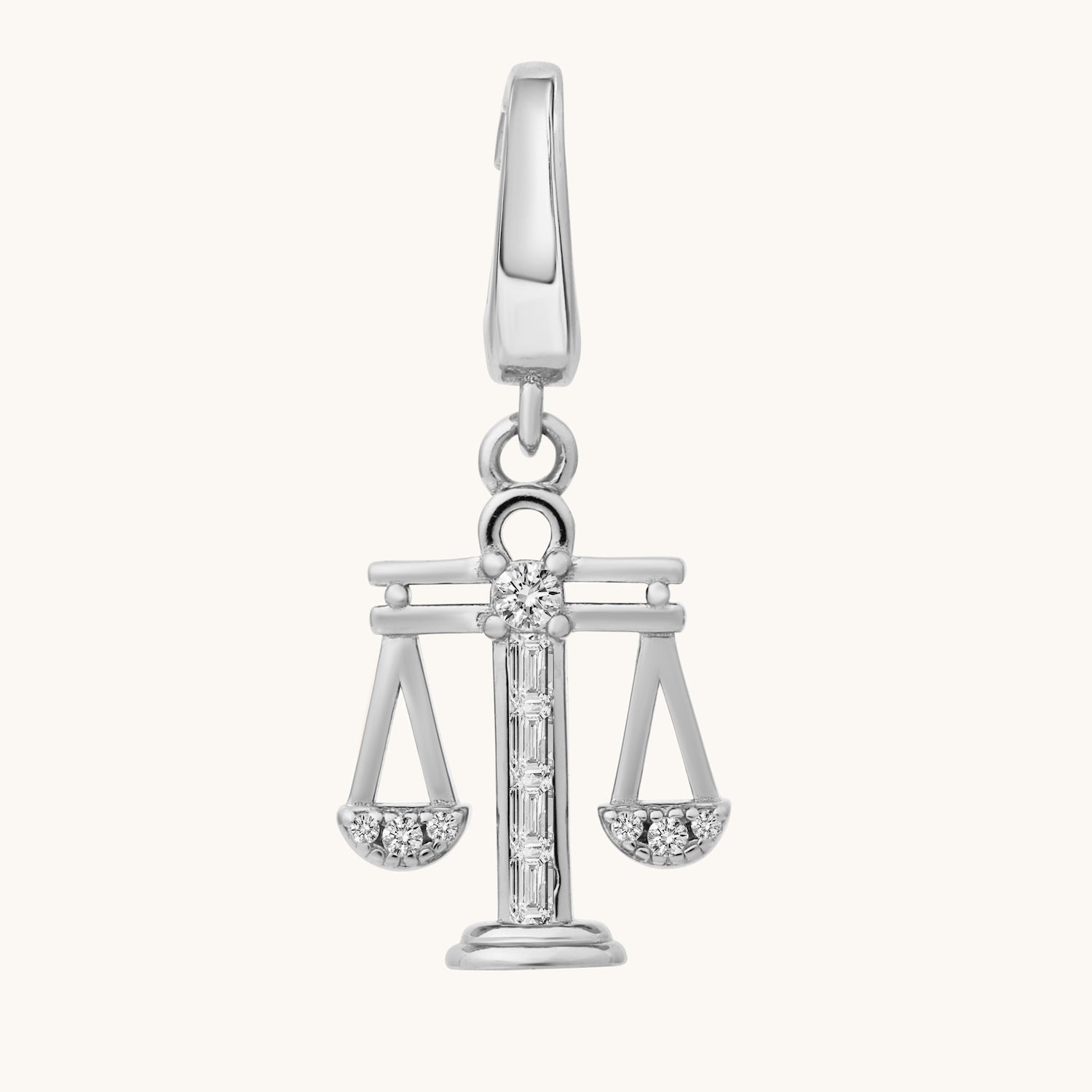 Silver pendant with a design resembling the scales of justice on a white background