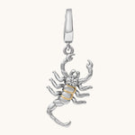Silver and gold scorpion pendant on a white background