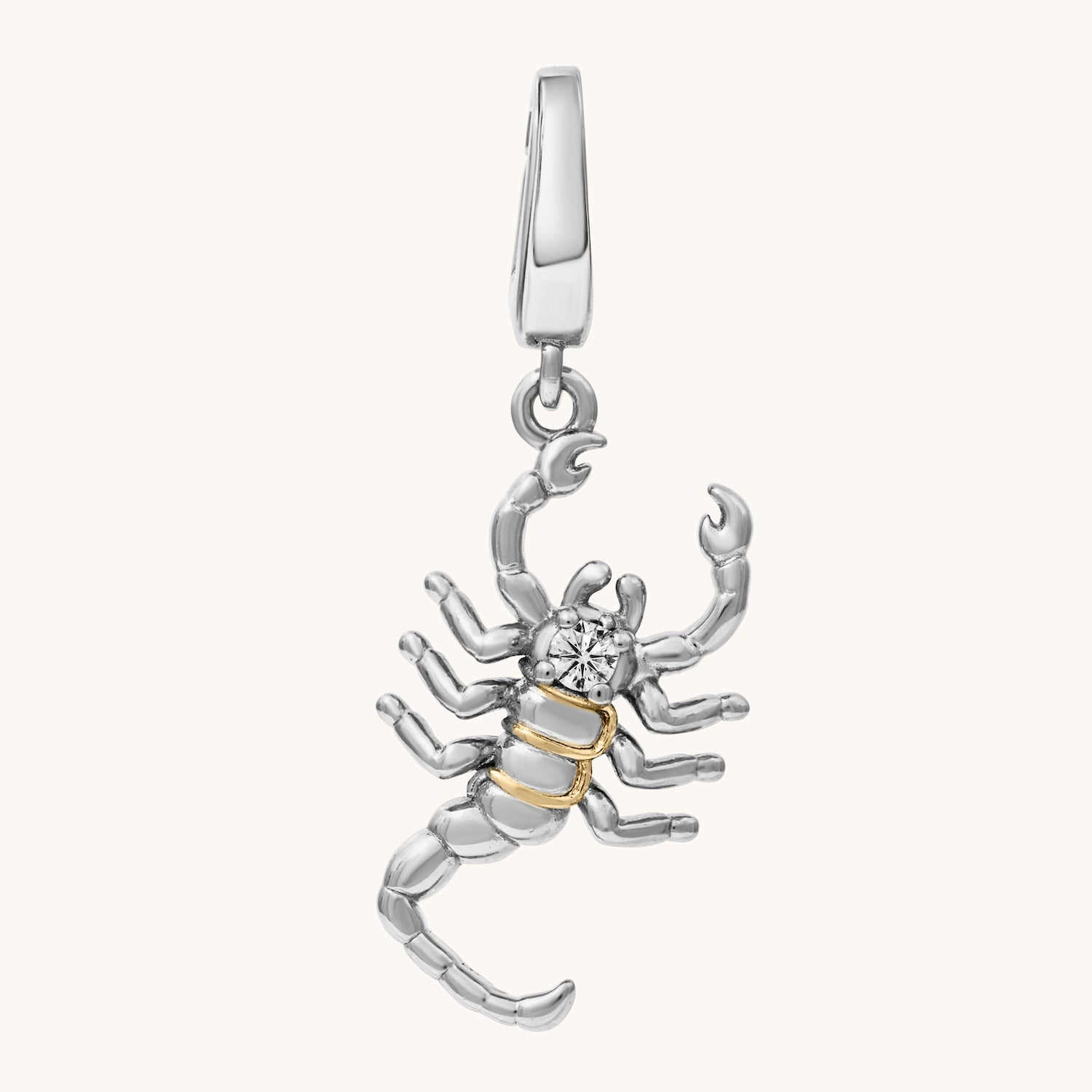 Silver and gold scorpion pendant on a white background