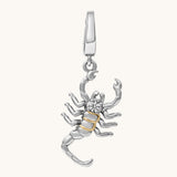Silver and gold scorpion pendant on a white background