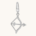 Silver bow-shaped pendant with white topaz stones on a white background