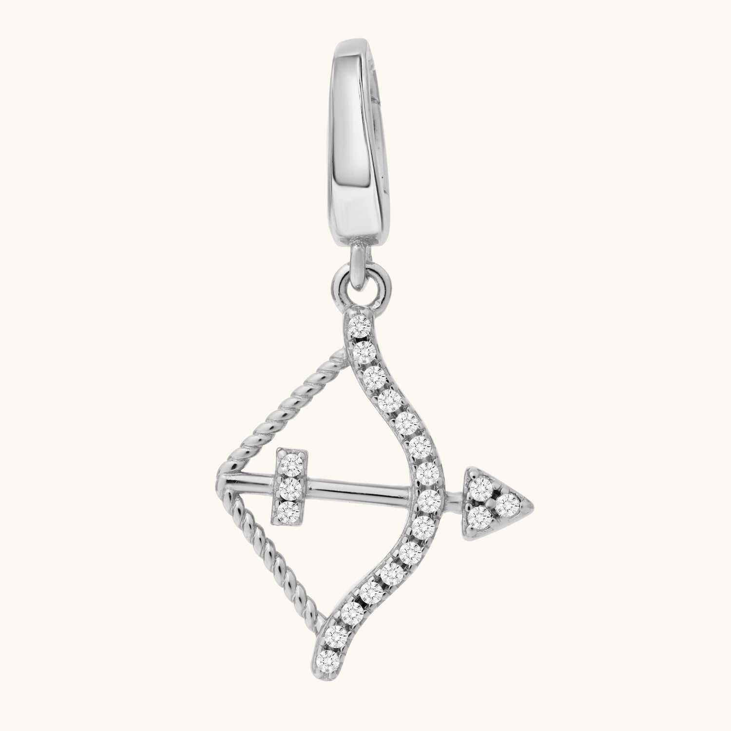 Silver bow-shaped pendant with white topaz stones on a white background