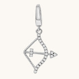 Silver bow-shaped pendant with white topaz stones on a white background