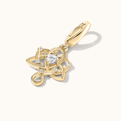 Gold pendant with a central white gemstone on a white background
