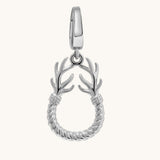A silver charm featuring a twisted rope circular body with two antler-like branches extending upward from the top, shown on a plain off-white background.
