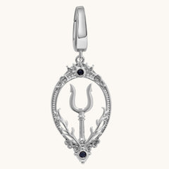 A silver-toned teardrop-shaped pendant charm featuring a central trident symbol, ornate filigree borders, and two small black gemstone accents, shown on a light cream background.