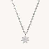 Silver necklace with a flower pendant on a white background