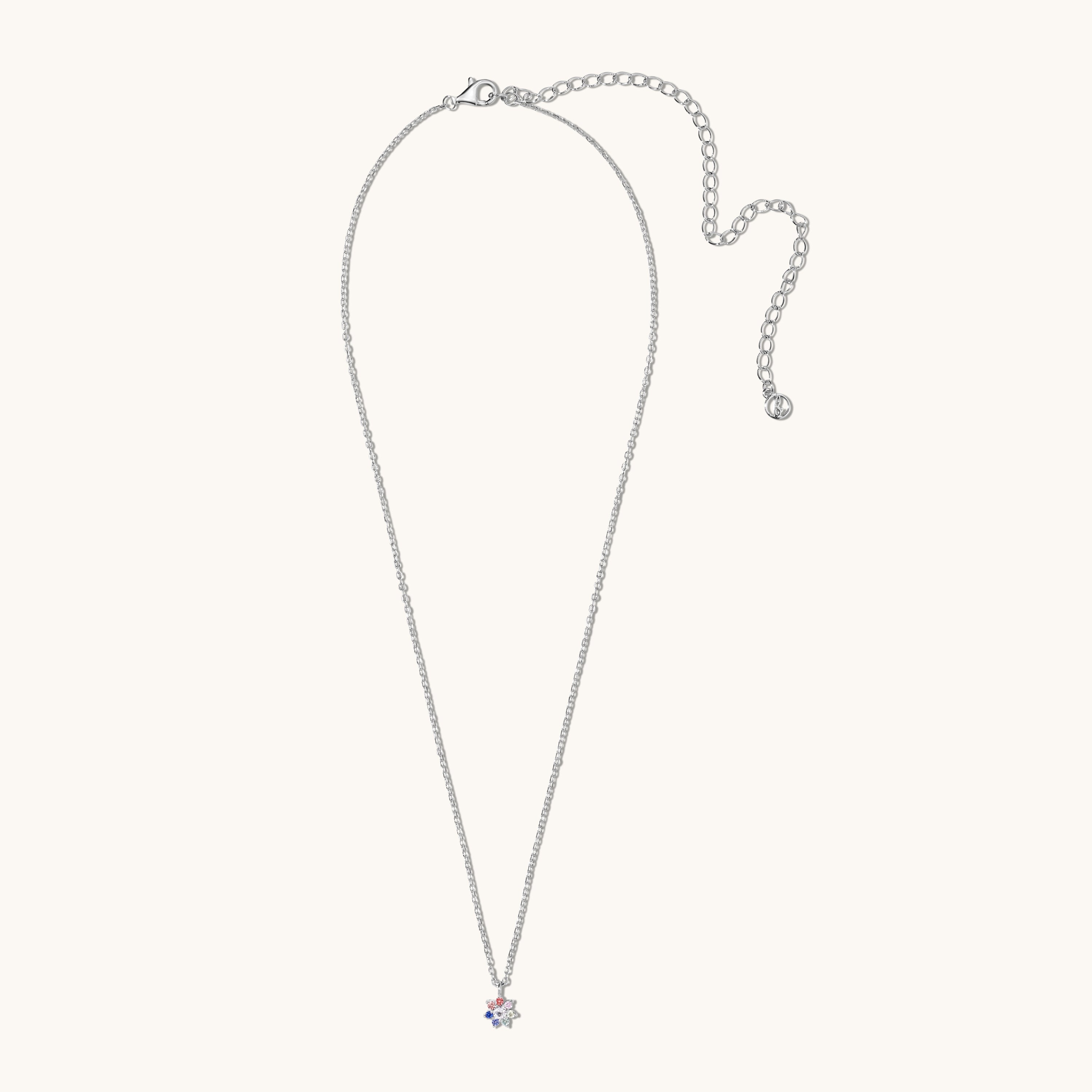 Silver necklace with a small pendant on a light gray background