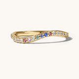 Gold ring with colorful gemstones on a white background