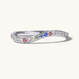 Silver ring with colorful gemstones on a white background
