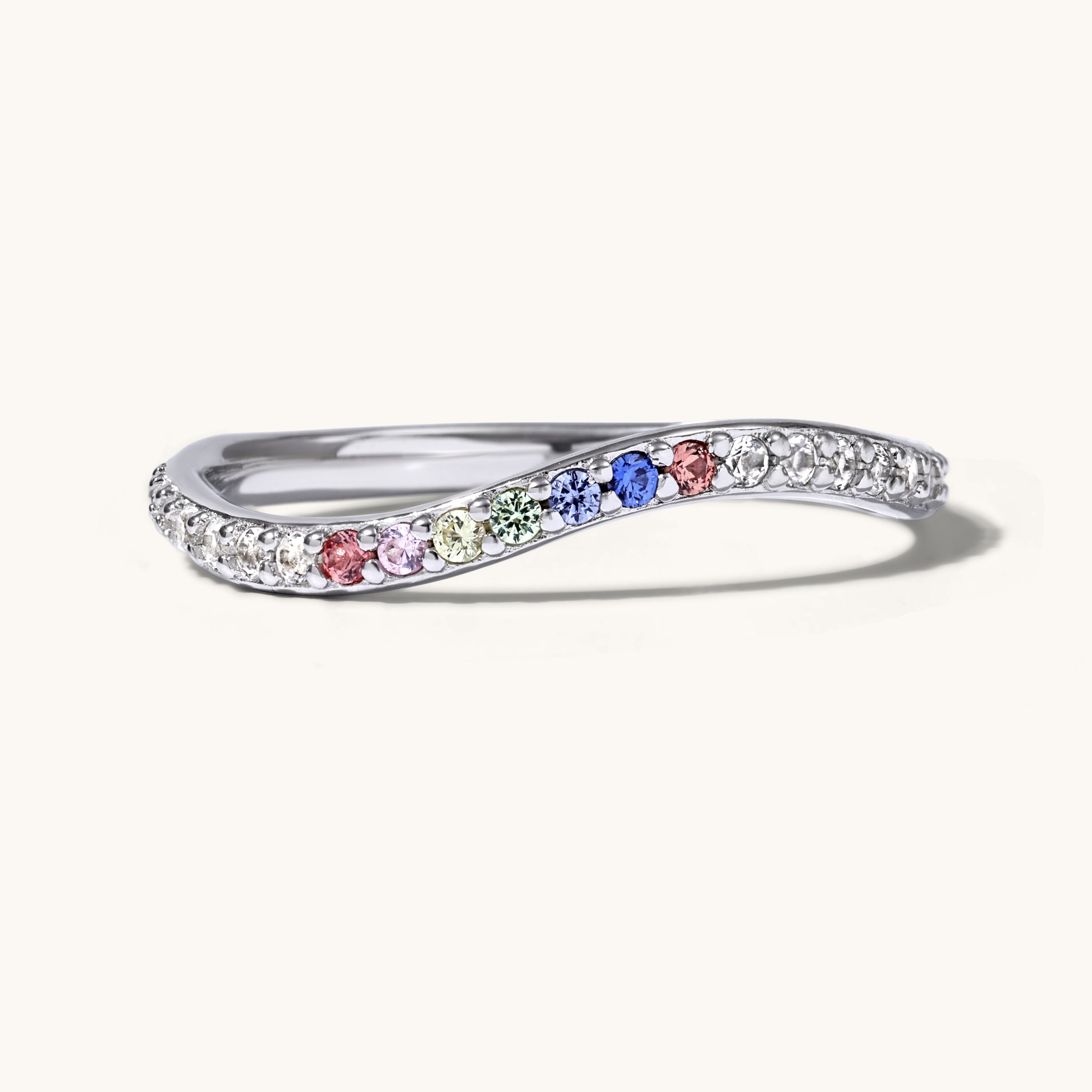 Silver ring with colorful gemstones on a white background
