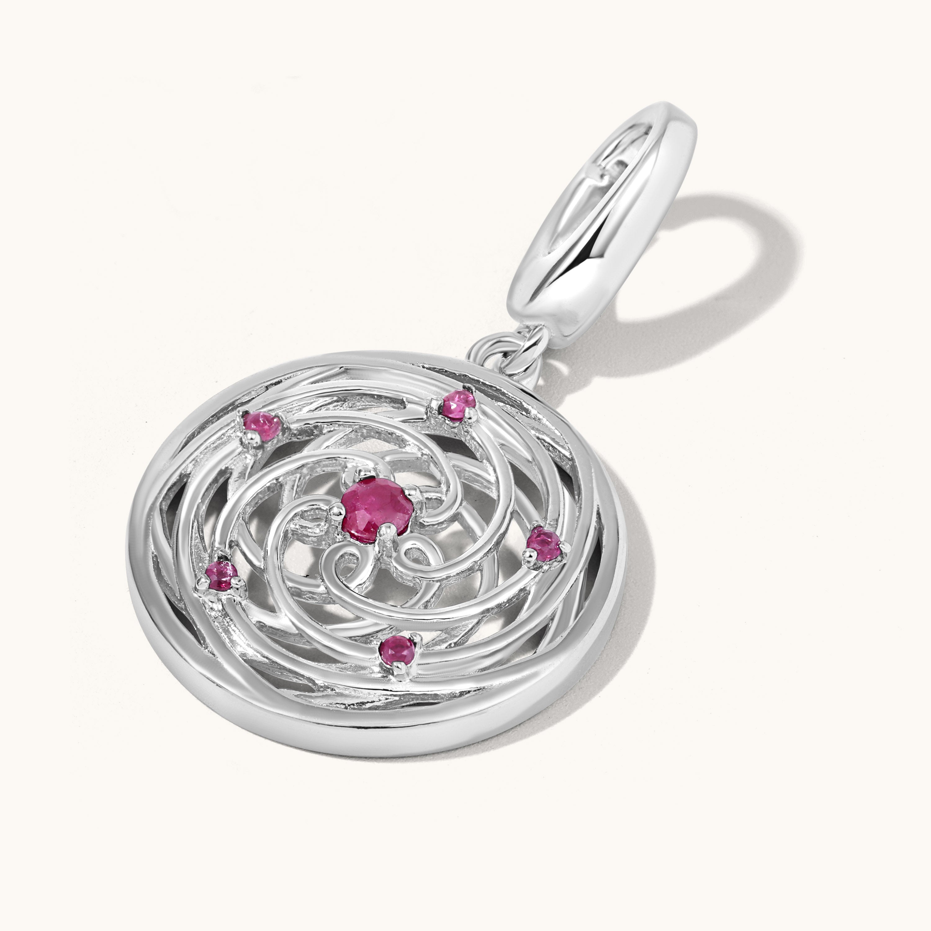 Silver pendant with pink gemstones on a white background